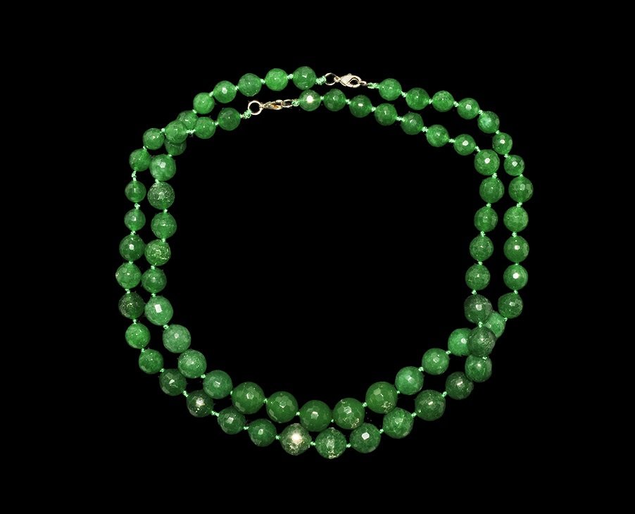 Near Eastern Style Facetted Green Bead Necklace Pair: A group of two restrung graduated necklaces of undated archaistic green glass facetted beads, each with modern clasp. 186 grams, 51-54 cm (20 - 21 1/4"). Private collection, London, UK; acquired prior