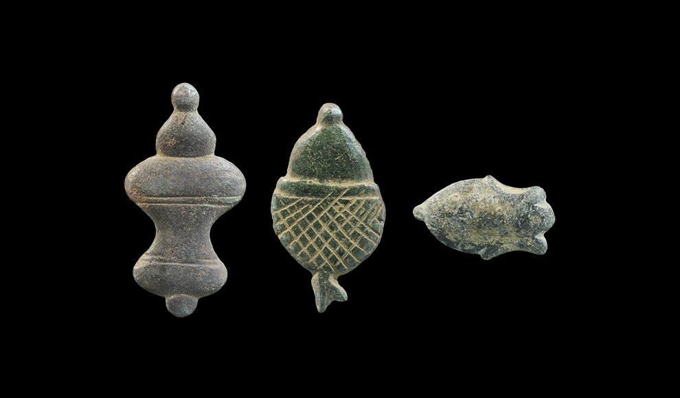 Medieval Bronze Horse Harness Decorations: 14th-16th century AD. A mixed group of harness mounts comprising:an escutcheon, gilded; a bell with knop finial; an acorn. 19 grams total, 28-46 mm (1 - 1 3/4"). Found Swanmore, Winchester, Hampshire,