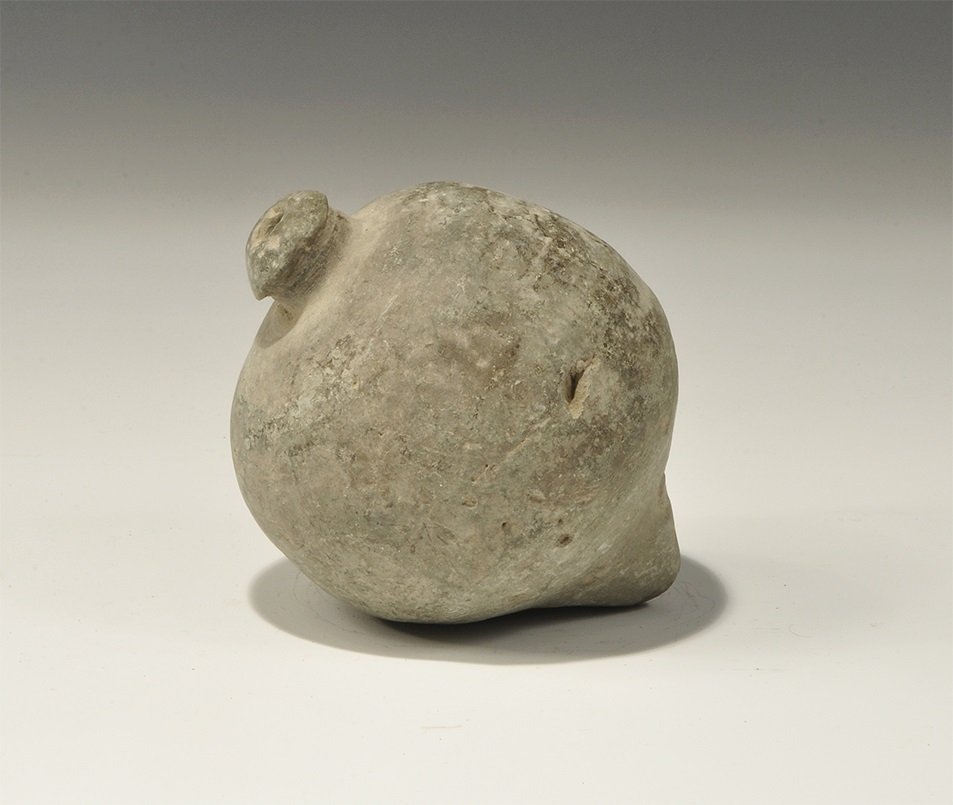 Byzantine Ceramic 'Greek Fire' Hand Grenade: 10th-11th century AD. A hollow globular vessel, intended to be filled with flammable liquid and a wick, and used as a hand grenade; the underside with circumferential incised ribs, domed and waisted r
