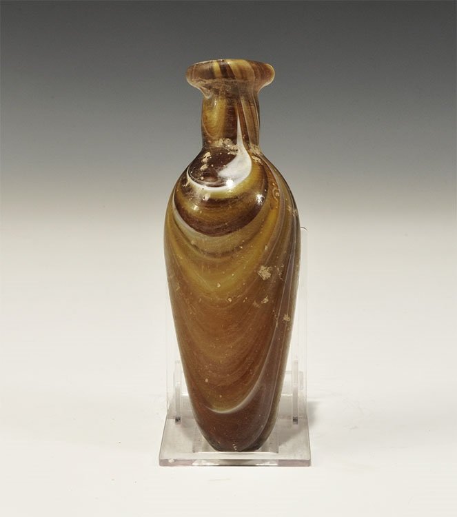 Roman Style Marbled Glass Bottle: An undated archaistic mottled brown and yellow glass bottle of alabastron form with rolled rim, hole to the underside. 108 grams, 14cm (5 1/2"). Private collection, North London; acquired in the early