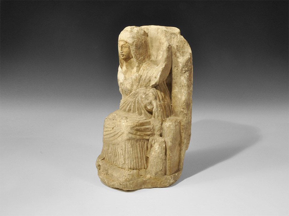 Romano-Egyptian Gypsum Plaster Statue of Isis Seated: 1st century BC-1st century AD A carved statue of the goddess Isis, seated, wearing a loosely draped mantle over a chiton; the face with lentoid eyes framed by a tripartite wig; oinochoe by her left fo