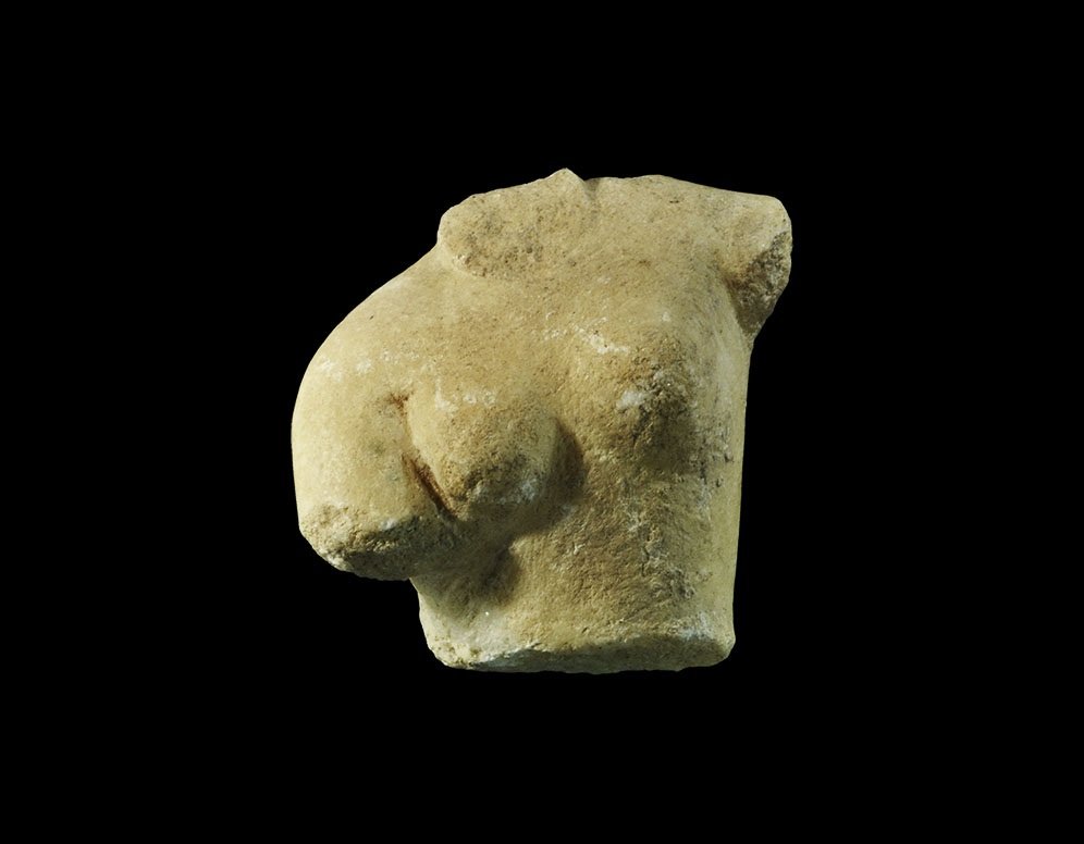 Roman Marble Venus Anadyomene Torso: 1st century AD A carved figurine of a nude female with right arm lowered and left shoulder raised, the skin folded on the right side; probably a representation of Venus rising from the sea and wringin