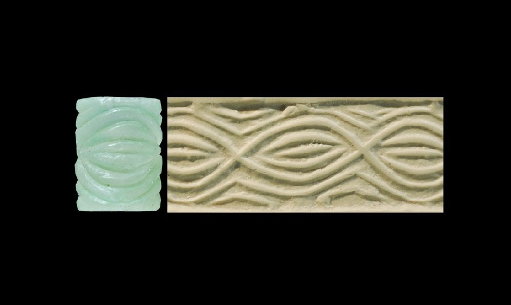 Near Eastern Mesopotamian Calcite Cylinder Seal: Early Dynastic period, circa 2800 BC A carved pale green calcite seal with intaglio design of running wave patterns. 2.65 grams, 14 mm (1/2"). Property of a North London businessman; acquired 1968-198