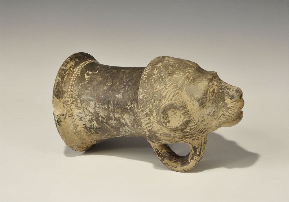 Near Eastern Graeco-Achaemenid Ceramic Rhyton: 5th-4th century BC A broad rhyton with bell-shaped upper, loop handle and lion-mask to the lower end, pierced at the nose; a band of impressed pellets to the neck. 669 grams, 20 cm (8"). From an old G