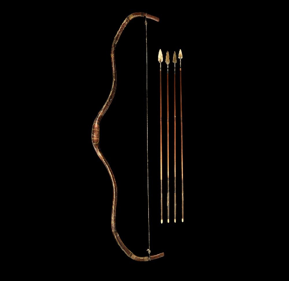 Indian Mughal Gilt and Painted Hunting Bow with Arrows: 17th-18th century AD A painted and lacquered wooden recurved self-bow with integral nocks; the body with running foliage designs to both faces; sinew cord with loops; four arrows each with socketted h
