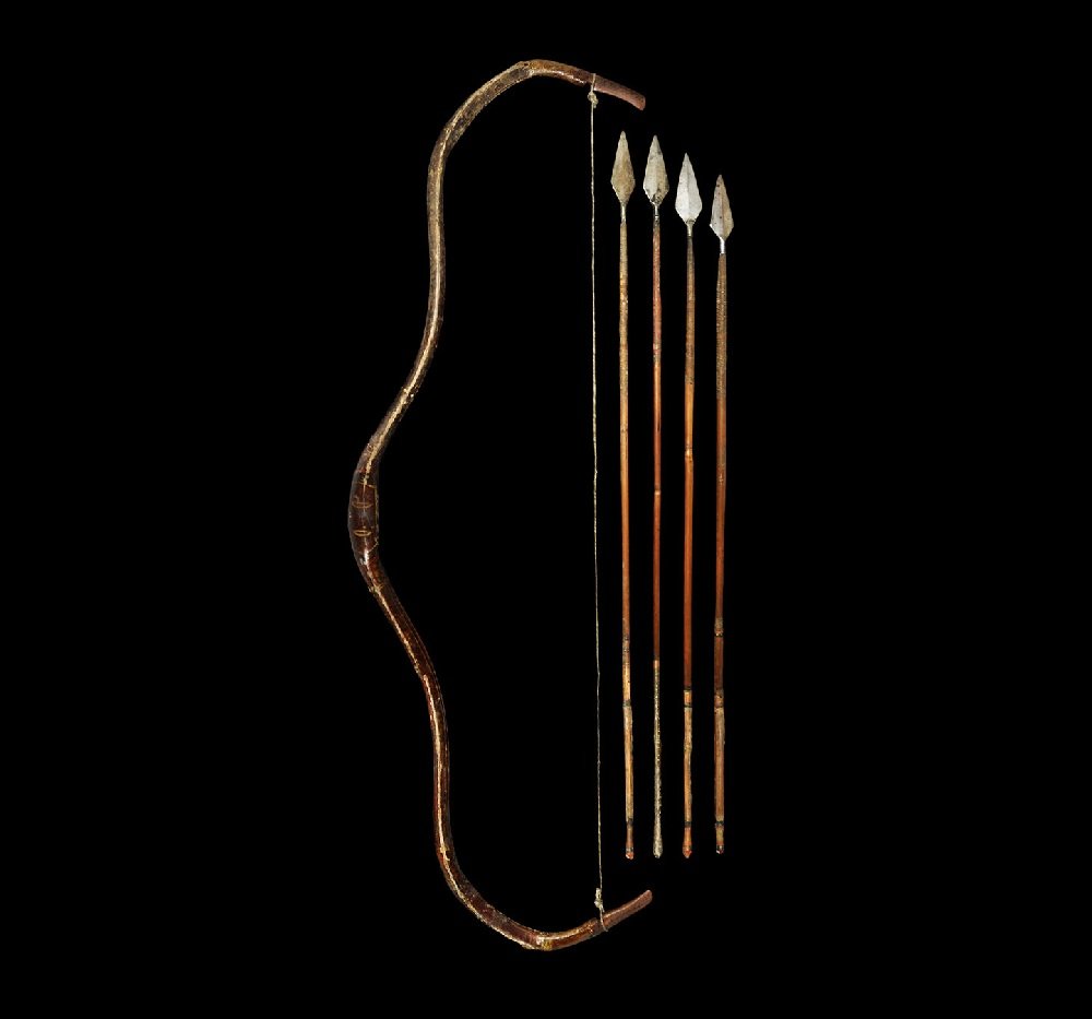 Indian Mughal Gilt and Painted Hunting Bow with Arrows: 17th-18th century AD A painted and lacquered wooden recurved self-bow with integral nocks; the body with running foliage designs to both faces; sinew cord with loops; four arrows each with socketted h