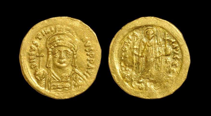 Ancient Byzantine Coins - Justinian I - Gold Angel: Struck 527-538 AD, Constantinople mint. Obv: D N IVSTINI-ANVS P P AVG legend with helmeted and cuirassed bust facing, holding cross on globe and shield. Rev: VICTORI-A AVGGG legend and officina letter