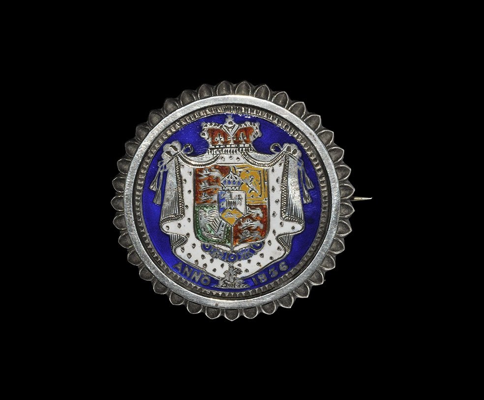English Milled Coins - William IV - 1836 - Enamelled: Coin dated 1836, mounted in ornamental surround. Rev: enamelled in five colours. Obv: concealed by locket (containing photograph of a naval gentlemen); with pin and marked to border 'STERLING SILVER' 