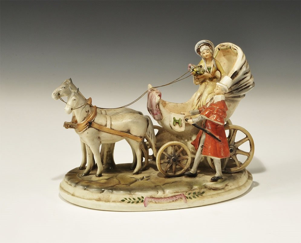 Antique Ceramic Gräfenthal Horse and Buggy Diorama: Early to Mid-20th century AD. A white-glazed figurine group comprising a gentleman in tall hat and cape opening the door of a carriage for a setaed lady with bonnet and bunch of flowers, two horses be