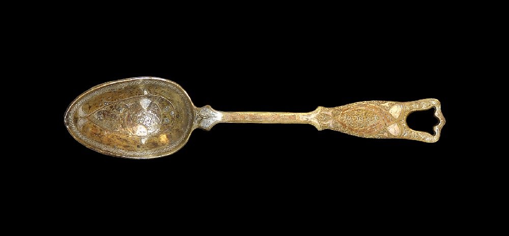 Islamic Style Bronze Large Spoon with Silver Inlay: An undated archaistic cast spoon with inlaid copper and silver fish to the handle and bowl, inlaid guilloche. 1.5 kg, 49.5 cm (19 1/2"). Property of a London gentleman; acquired 1990-2000.