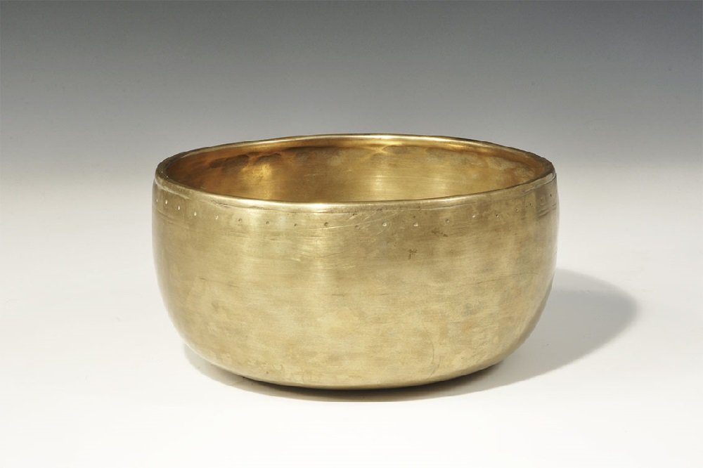 Chinese Tibetan Bronze Singing Bowl: Late 18th century AD. A squat bowl with thickened rim, concentric circles to the inner face, band of ring-and-dot motifs below the rim to the outer face. 840 grams, 18.5cm (7 1/4"). Ex Brayne collecti