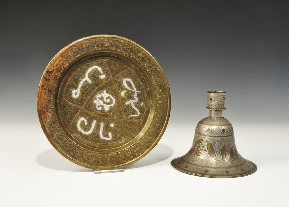 Islamic Brass Inlaid Tray and Hookah Base Group: Late 19th-early 20th century AD. A group of two calligraphic items comprising: a white metal hookah base with, bell-shaped with scrolled foliage to the surface, bands of roundels and reserved calligra