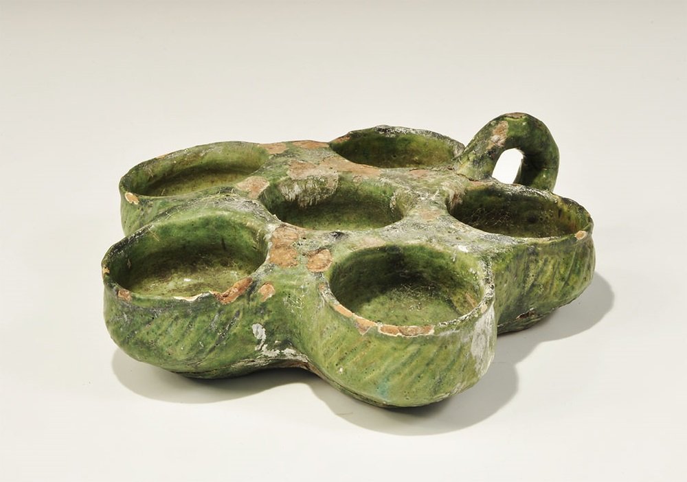 Islamic Glazed Ceramic Six-Bowl Spice Tray: 12th century AD. A ceramic green-glazed spice tray comprising six bowls with loop handle to the rear. 1.4 kg, 24 cm (9 1/2"). From a large London collection; formed between 1980-late 1990s.