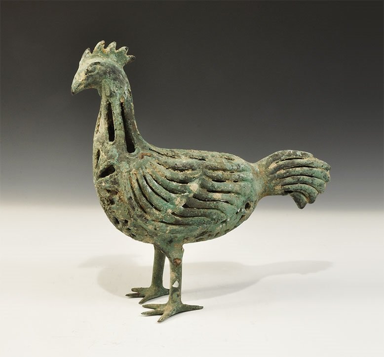 Islamic Bronze Openwork Cockerel Figurine: An undated archaistic cast figurine of a cockerel with openwork panels to the neck, body, wings and tails. 2.5 kg, 31 cm (12 1/4"). From an old London collection, formed in the 1980s.