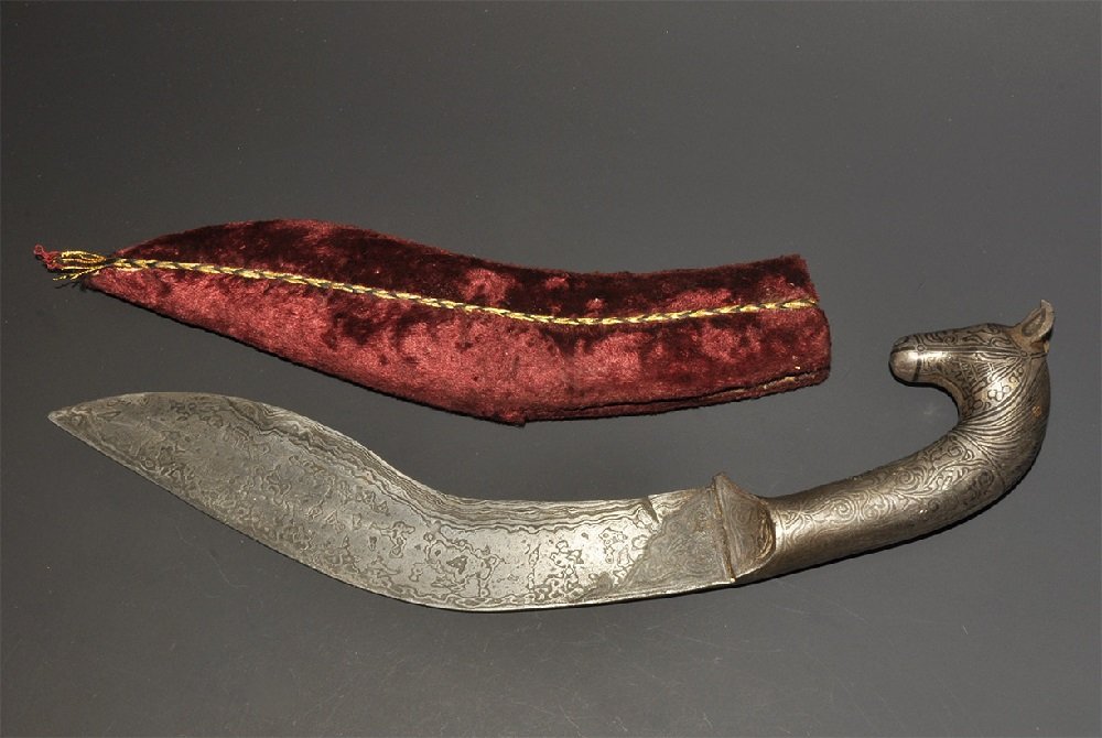 Islamic Ottoman Dagger and Sheath: 20th century AD. A steel dagger with curved single-edged blade, short grip and horse-head pommel; fabric-covered sheath. 241 grams, 32.5cm (12 3/4"). From a large London collection; formed between 198