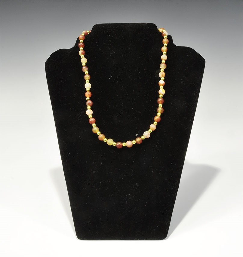 Chinese Agate and Carnelian Bead Necklace: 20th century AD. A necklace of small spherical beads with gilt spacers, omega closure. 37 grams, 23cm (9"). From a London collection; formed between 1990-2000. TimeLine Auctions Ltd arranges printed c