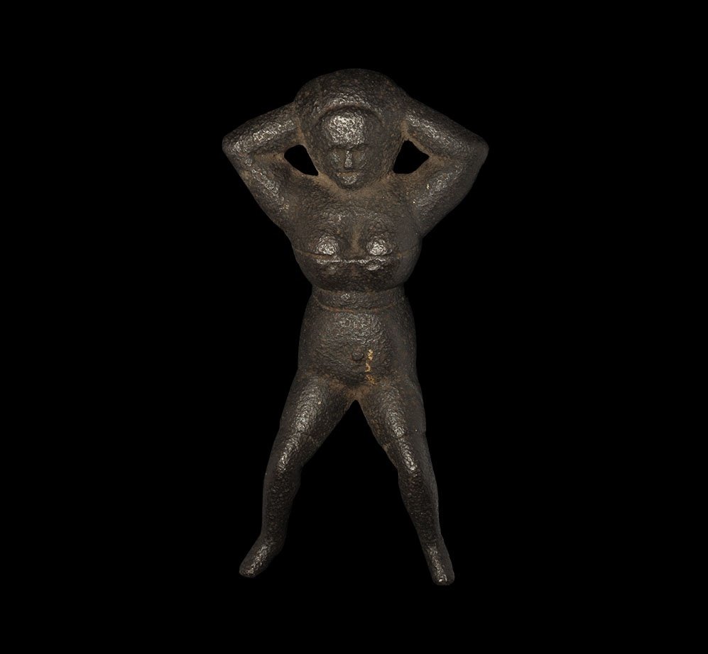 Antique Victorian Cast Iron 'Naughty Nellie' Bootjack: 19th century AD. A cast bootjack formed as a supine female clad in her underwear, arms behind her head and legs raised and spread; probably USA made. 1.3 kilograms, 22.5cm (9"). Property of a Suffolk