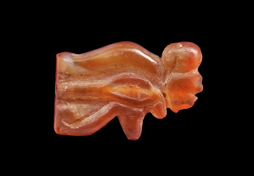 Egyptian Carnelian Eye of Horus Amulet Bead: Late Period, 664-332 BC. A carved bead of the wedjat with incised detail to the upper face. 5.35 grams, 29mm (1 1/4"). Ex Dolman collection; collected in the 1930s. TimeLine Auctions Ltd arranges prin