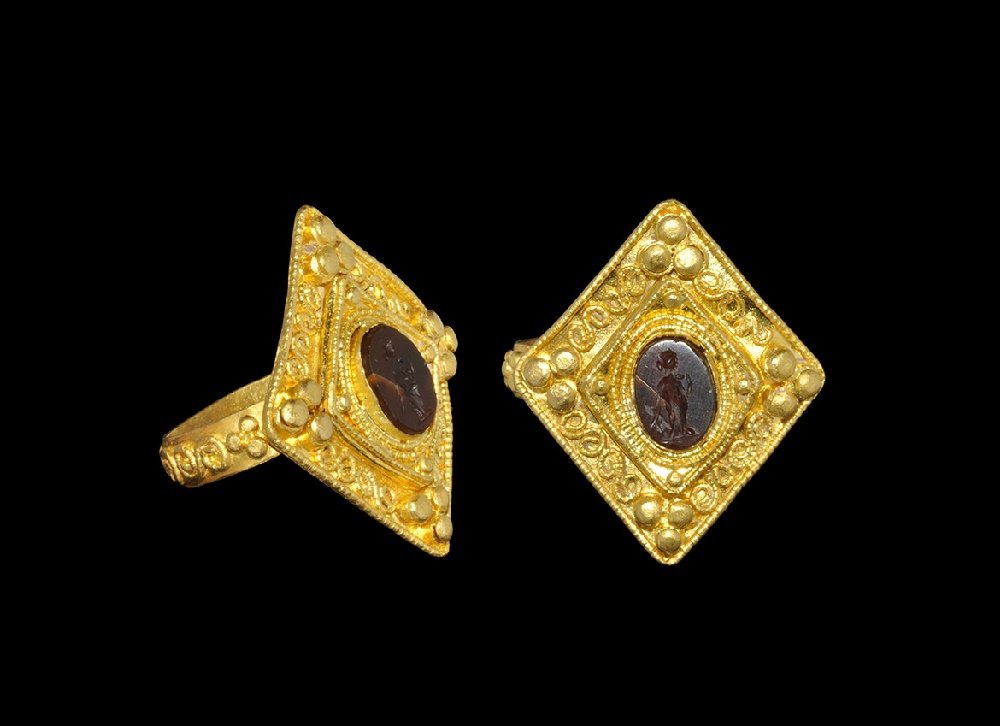 Roman Carnelian Figural Intaglio: 3rd-4th century AD. Carved intaglio of a standing robed female in profile in a sympathetic modern setting. 9.77 grams, 29mm overall, 16.13mm internal diameter (approximate size British K 1/2, USA 5 1/