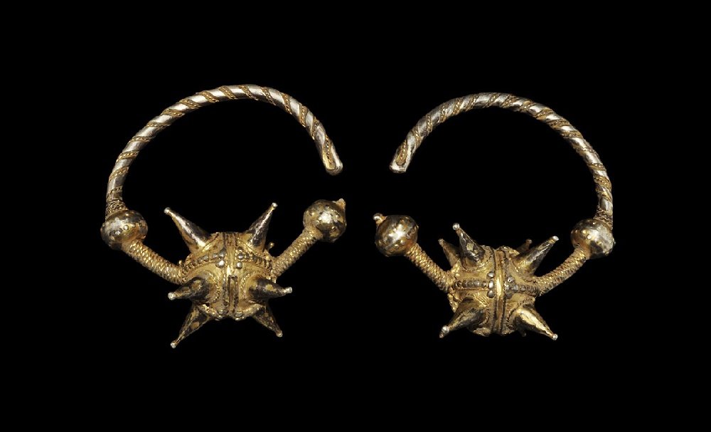 Byzantine Silver-Gilt Spiked Temple-Ring Pair: 7th-10th century AD. A matched pair of tubular temple-rings, each formed as a crescentic rod with three hollow bulbs and ropework bands; the bulbs with granule and filigree detail, the larger with con