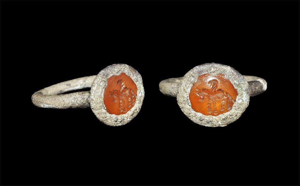 Near Eastern Sassanian Ring with Pegasus Intaglio: 224-651 AD. A silver round-section hoop supporting an elliptical plaque with inset carnelian intaglio of a winged horse. 4.06 grams, 23mm overall, 14.72mm internal diameter (approximate size British H
