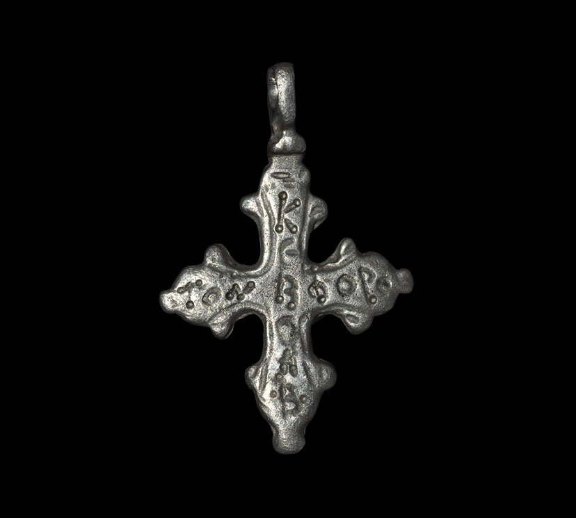 Byzantine Silver Inscribed Cross Pendant: 7th-8th century AD. A flat-section pendant with integral suspension loop, trefoil finials; inscribed vertically '??R???' and horizontally '??? ????'. 2.29 grams, 31mm (1 1/4"). Property of a Middlesex