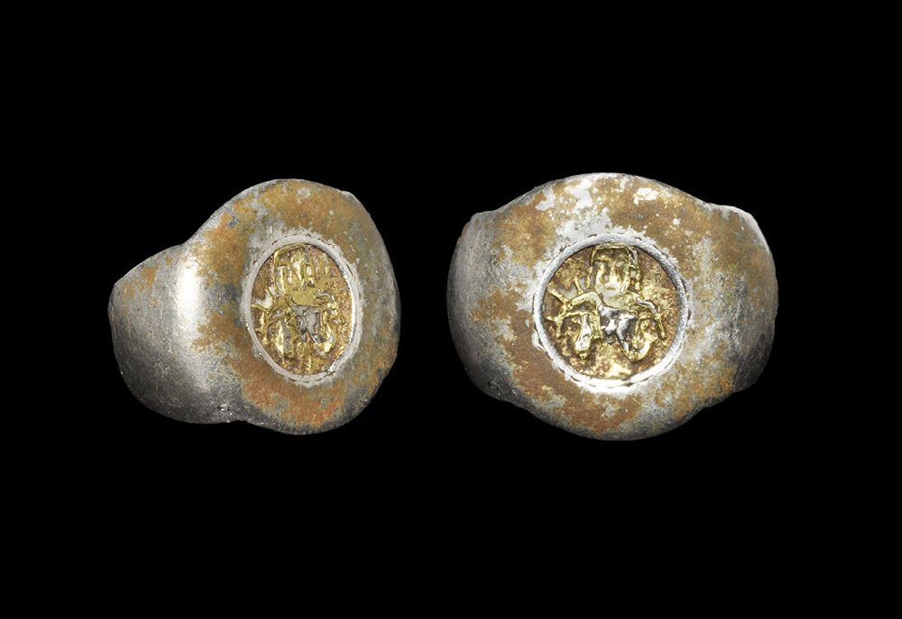 Byzantine Silver Ring with Gold Saint Appliqué: 6th-8th century AD. A D-section hoop with expanding shoulders, discoid plaque with inset gold appliqué of a nimbate bearded figure. 8.57 grams, 25mm overall, 15.75mm internal diameter (approximate si