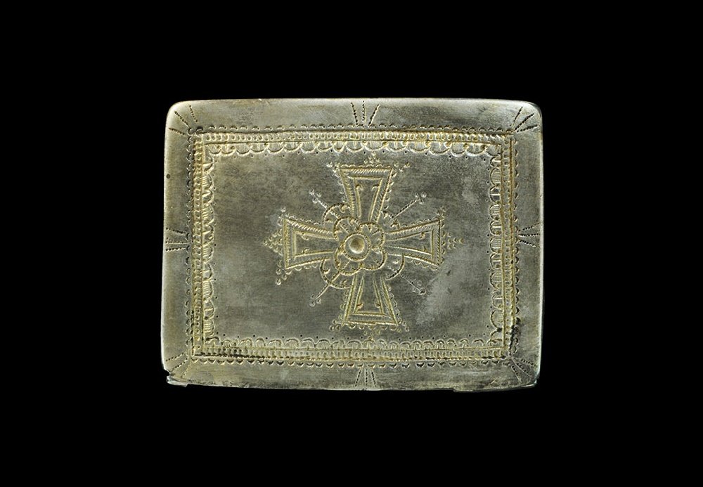 Post-Medieval Silvered Book Cover: 17th-18th century AD. A rectangular plaque with lip to three sides, punched border enclosing a central expanding-arm cross with central pellet and rosette, pelletted bars and bands of lunate punchmark