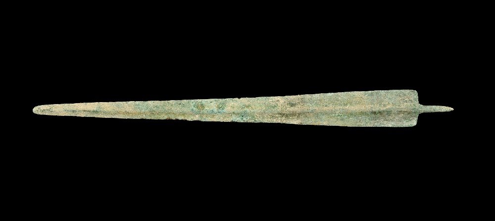 Greek Trojan Bronze Sword Blade: 12th-10th century BC. A cast Bronze Age rapier with narrow triangular blade, thick rounded midrib, rounded tip, scooped shoulders with lateral flanges, round-section tang with flattened finial. Cf. Br