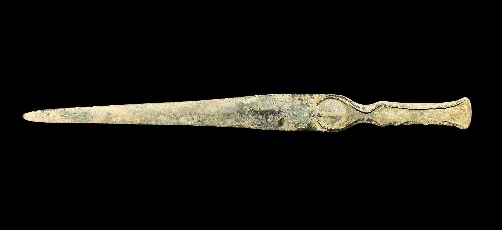Near Eastern Marlik Bronze Dagger: 14th-10th century BC. A cast lentoid-section Bronze Age dagger with penannular raised panel at the shoulder, flanges to the edges of the integral grip, rounded tip. Cf. Khorasani, M.M. Arms and Armour