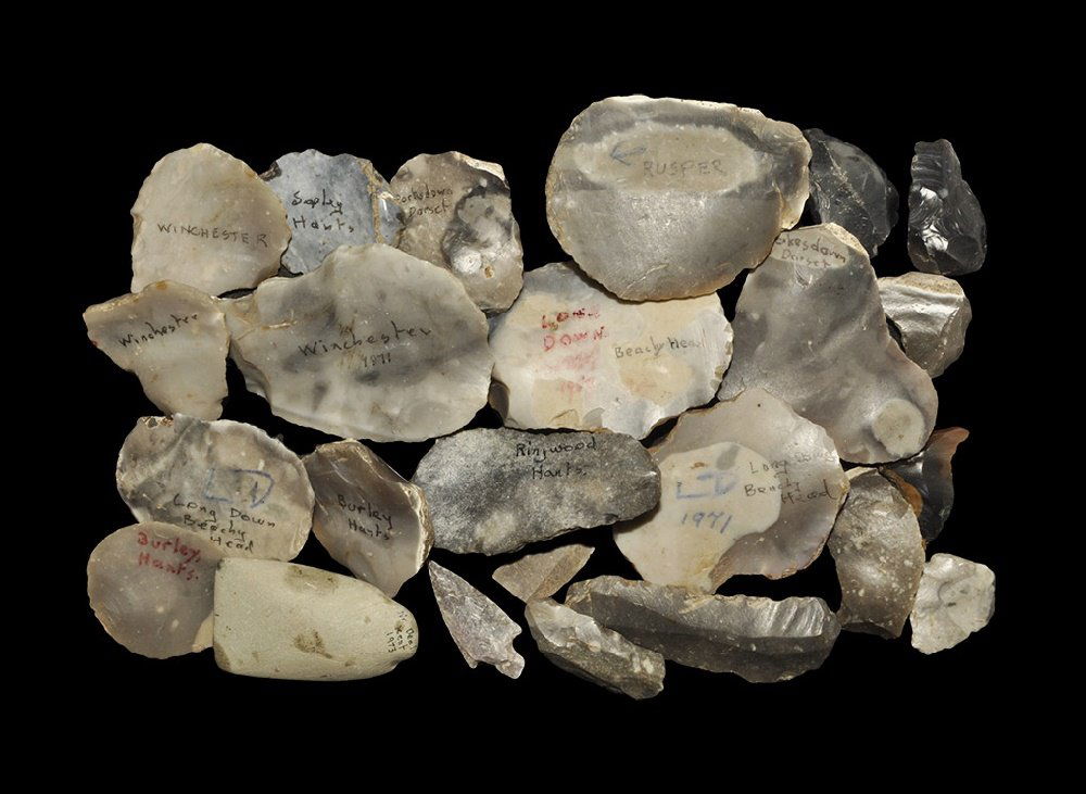 Stone Age English Flint Arrowhead and Implement Group: Mesolithic to Neolithic, 10000-2500 BC. A mixed group of implements comprising: thirteen Neolithic scrapers some with inked findspots ('Long Down, Beachy Head'; 'Burley, Hants'; 'Pokesdown, Dorset'; '
