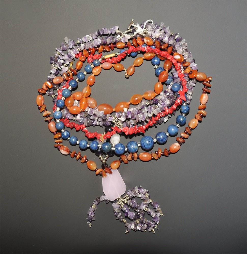Vintage Stone Bead Necklace Group: 20th century AD. A mixed group of necklaces comprising: a double loop of irregular mainly amethyst beads and facetted dangle; one of blue glass globular beads; one of ovoid carnelian beads; one of irr
