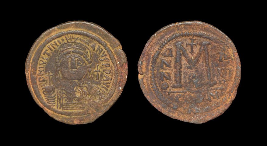 Ancient Byzantine Coins - Justinian I - Follis: . 527-565 AD, Constantinople mint. Obv: helmeted and cuirassed bust facing, holding cross on globe and shield, cross to right. Rev. Large M with ANNO-XVI across fields; cross above, B below and mintma