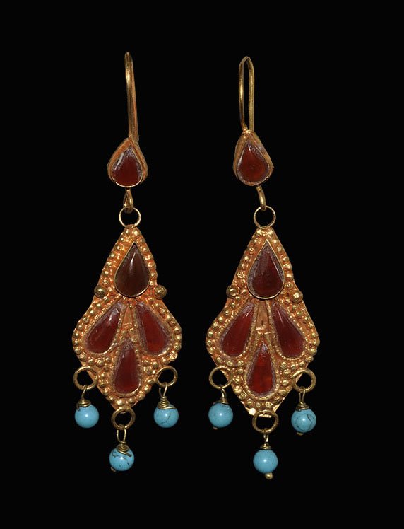 Near East Gilt Bedouin Earring Pair: . An undated archaistic gilt metal earring pair, with inset piriform carnelian panels, turquoise seed-bead pemdants. 7.16 grams, 70 mm (2 3/4"). UK art market. TimeLine Auctions Ltd arranges printed c