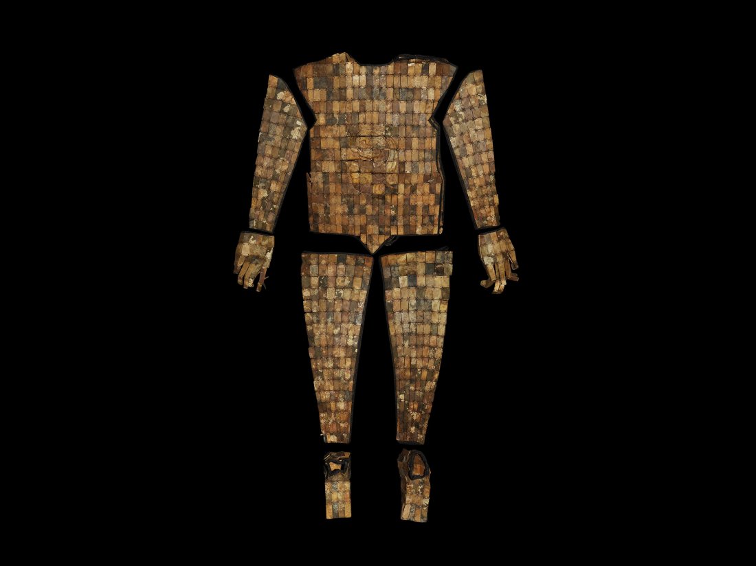 Chinese Style Warrior's Valedictory Jade Suit: . An undated archaistic Han Dynasty style life-size burial suit composed from 'jade' tiles, probably serpentine or bowenite, mainly rectangular in plan with some trapezoidal, rhomboidal, discoid and o