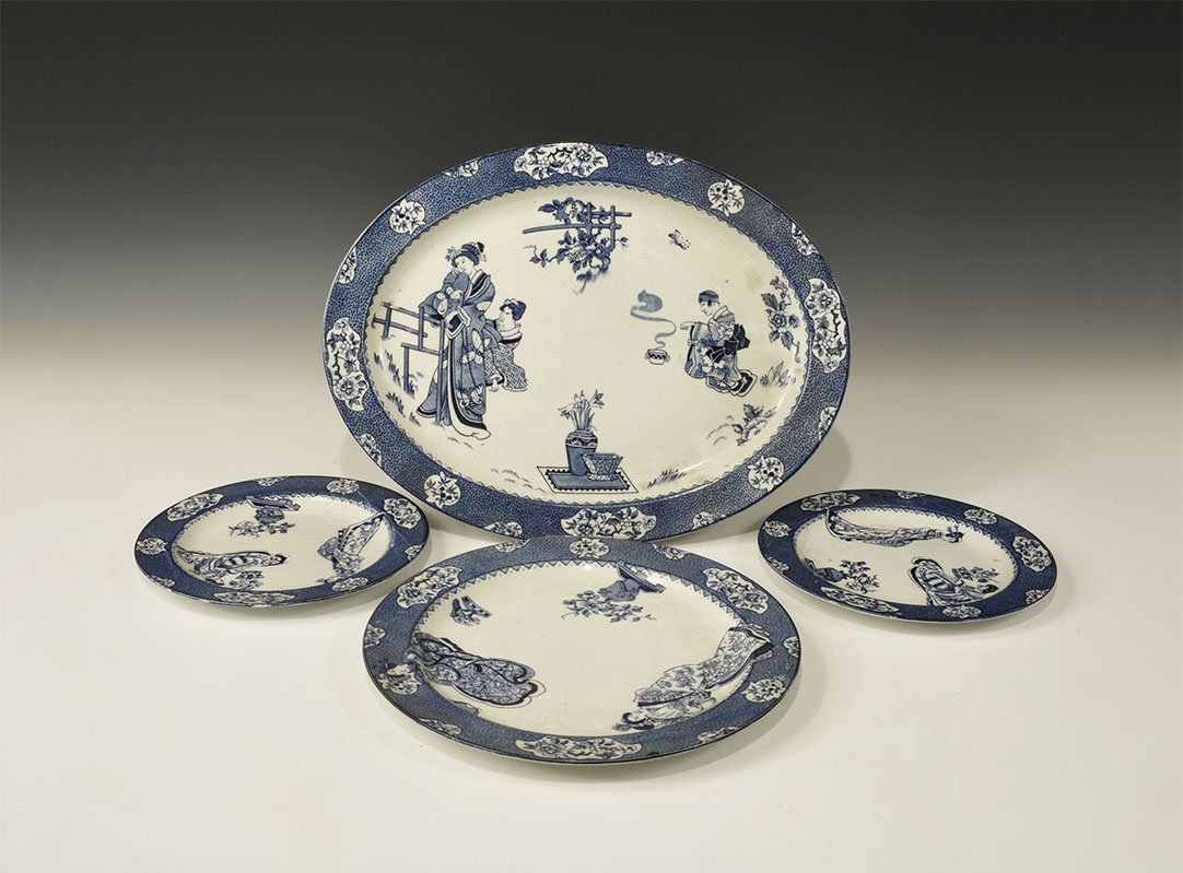 Antique Wood's Ware Ceramic Tsing Blue and White Plate: 1920s. A mixed group of tableware from the Wood's Ware Tsing range comprising: an elliptical platter with robed figures, flowers and a trellis; a circular plate and two side-plates, each with geishas 