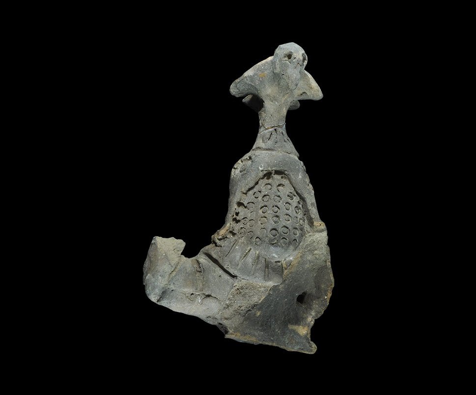Roman Ceramic Gladiator Figurine Fragment: 1st century BC-3rd century AD. A fragment of terracotta model of a gladiator of the thrax type with large helmet and crest; the visor with annular impressions representing a grill, rosettes to the tem