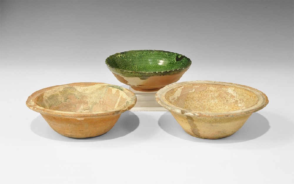Byzantine Ceramic Shipwreck Bowl Group: 10th-13th century AD. A mixed group of bowls comprising: a terracotta bowl with broad flange rim, drizzled cream and green glaze to the inner face; one similar with marbled ochre glaze; one with basal