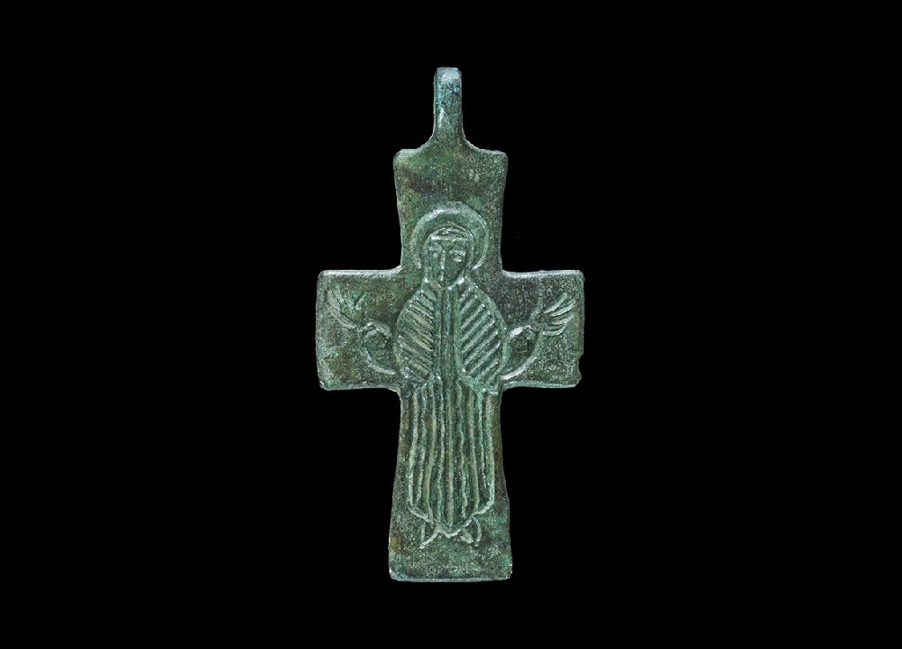Byzantine Bronze Pectoral Cross Pendant: 6th-10th century AD. A flat-section pendant with pierced lug, intaglio robed and nimbate figure in orans posture. 8.60 grams, 52mm (2"). Property of a London gentleman; acquired before 1980.