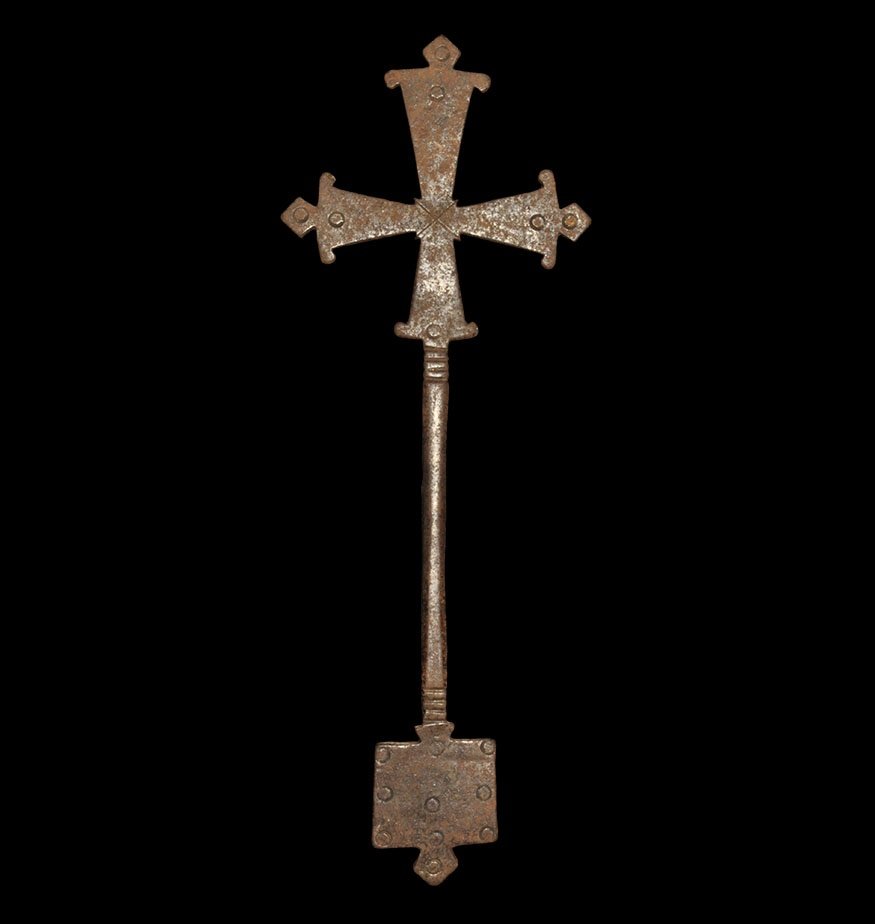 Post Medieval Ethiopian Bronze Cross: 18th-19th century AD. A cast hand-held cross with round-section shank, flared arms with punched annulets, square plaque with annulets and lozenge finial. 152 grams, 25cm (9 3/4"). Property of a West L