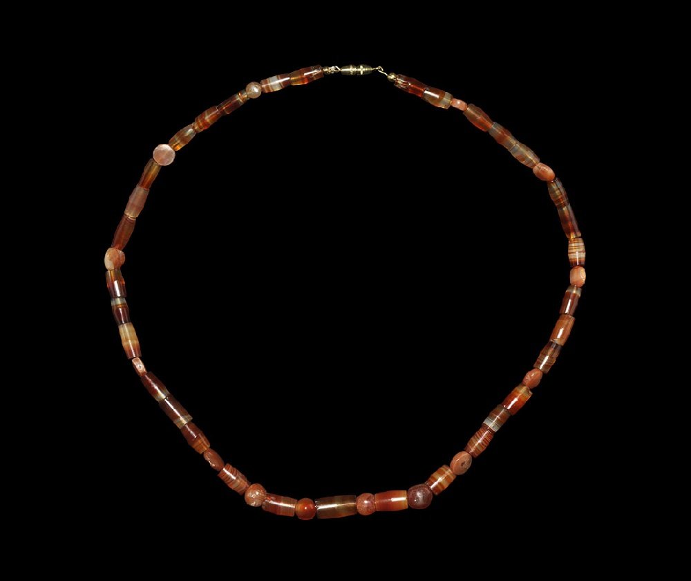 Near Eastern Banded Carnelian Designer Necklace: Early-Mid 2nd millennium AD. A restrung necklace of assorted cylindrical, oval and rounded matching banded cornelian beads; modern clasp. See Dubin, L.S. The History of Beads from 30,000 BC to the Pre