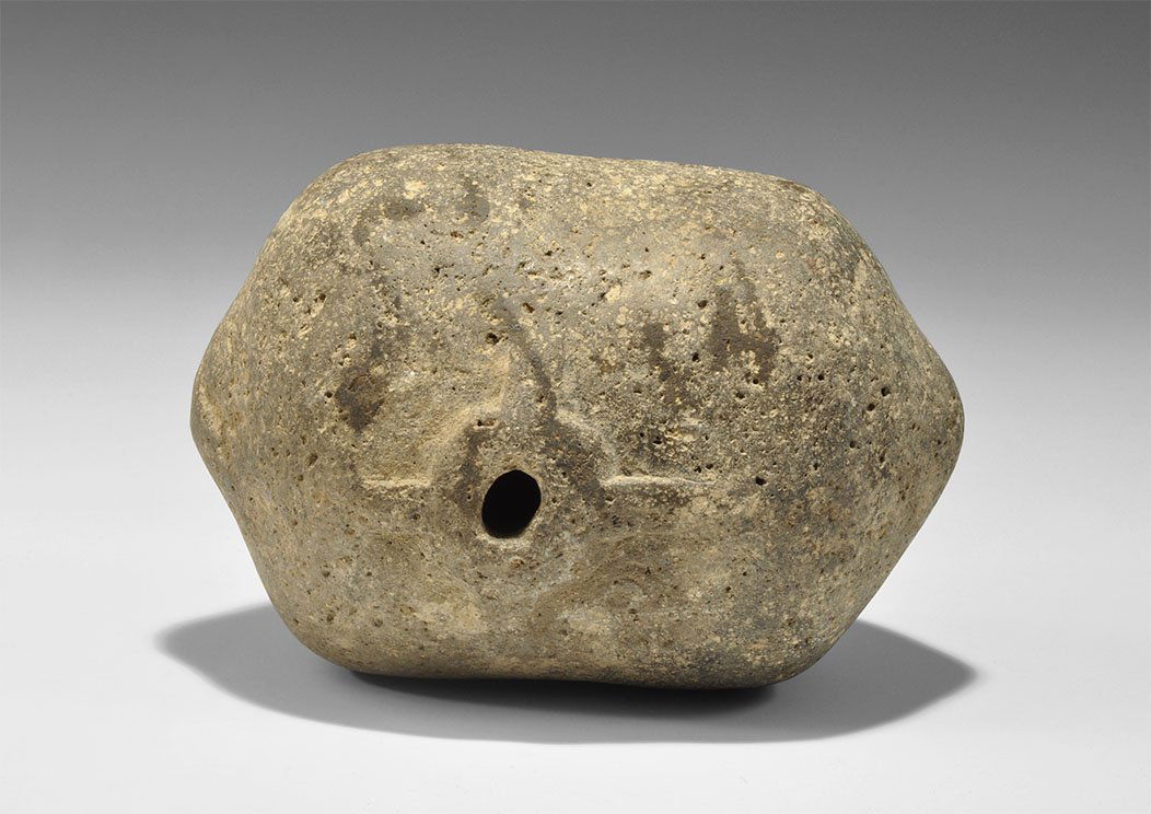 Byzantine Ceramic 'Greek Fire' Hand Grenade: 9th-11th century AD. A hollow-cast barrel-shaped vessel with conical ends, hole and raised dome to the top, lateral extensions. 1.1 kg, 14cm (5 1/2"). English private collection; acquired in the 1970s