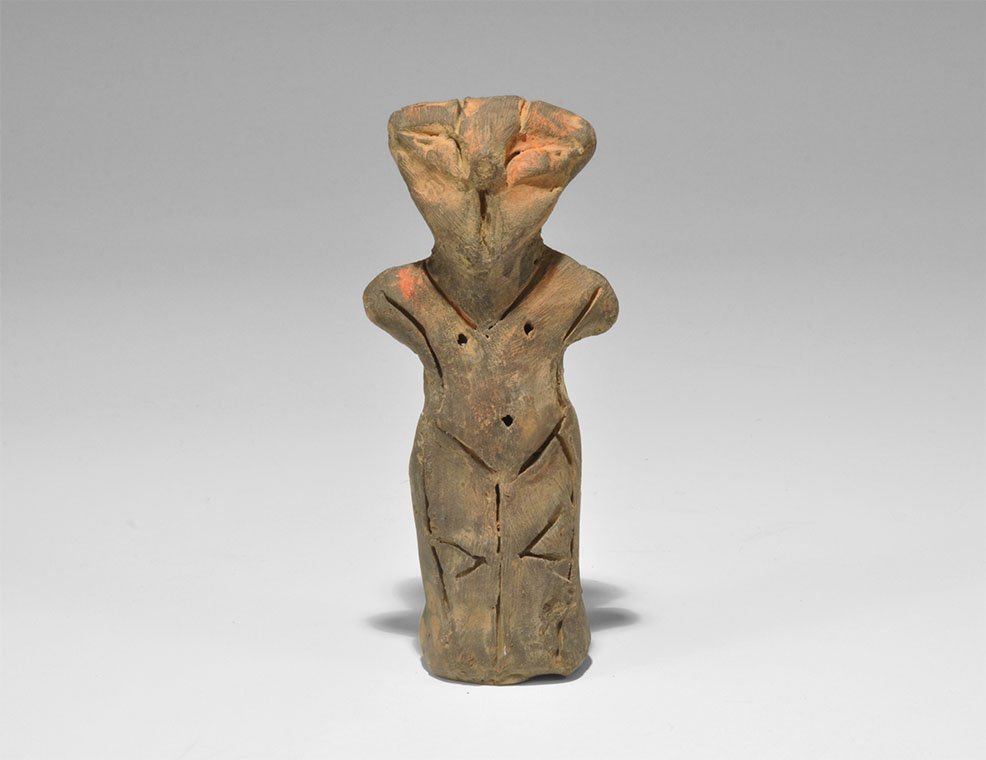Stone Age Vin?a Ceramic Figure: Neolithic, 5000-4000 BC. A terracotta robed figure with stub arms, pinched facial features; impressed point and incised triangular detailing. 115 grams, 10cm (4"). Property of a German collector; acqu