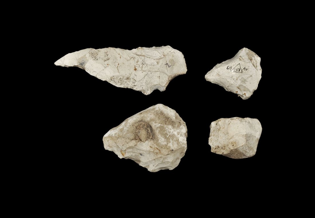 Stone Age British 'Avebury' Implement Group: Neolithic, 3000-2000 BC. A mixed flint group comprising: a narrow triangular point with curved profile; a D-shaped scraper; a nodule with one worked face; a trapezoidal scraper with old inked museum c