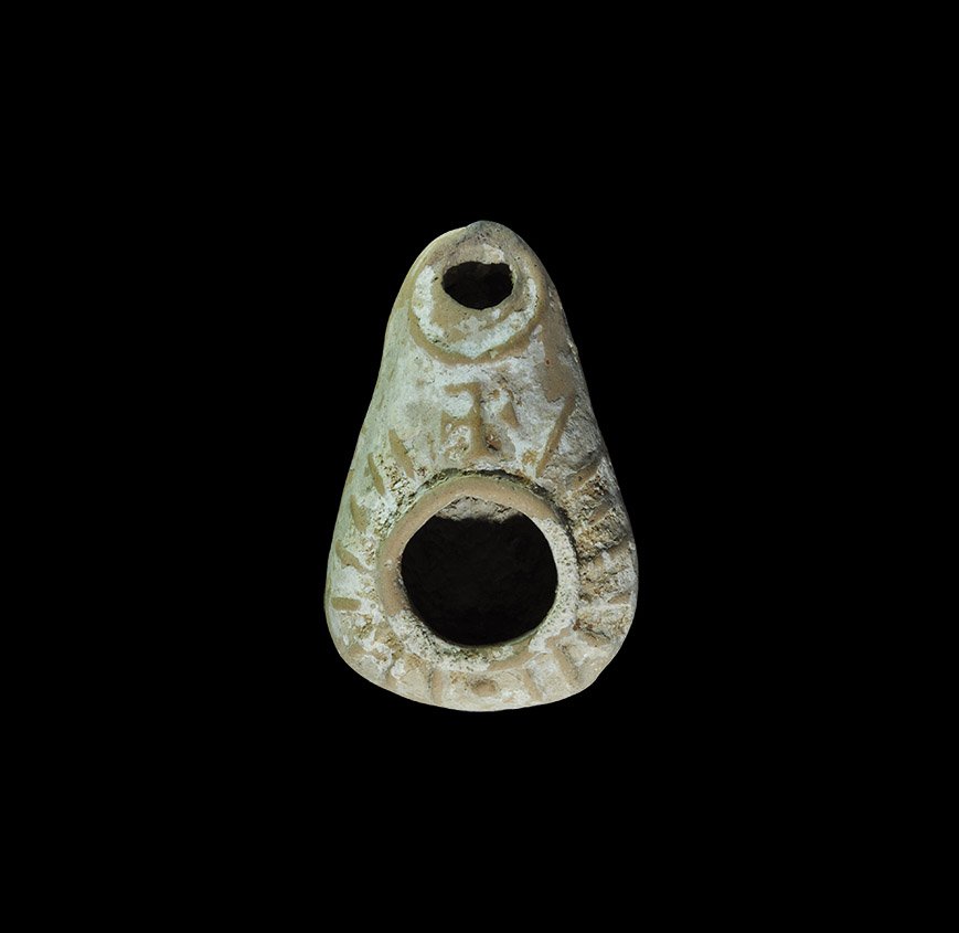 Byzantine Ceramic Oil Lamp with Cross: 5th-8th century AD. A terracotta moulded slipper-shaped lamp with basal ring, broad filler-hole, nozzle with outer ring; discus with radiating lines and cross potent to the centre. 37 grams, 73mm (3")