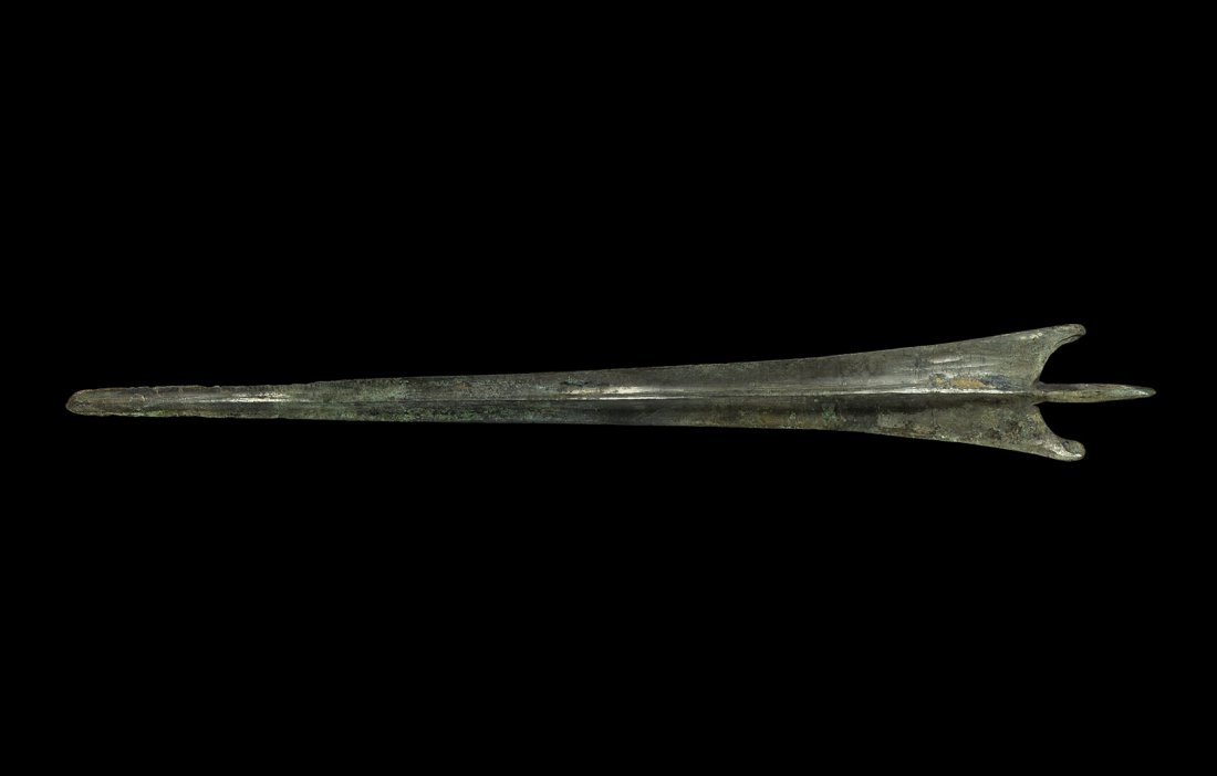Greek Trojan Bronze Sword Blade: 12th-10th century BC. A very long Troy type Bronze Age rapier with narrow triangular blade, thick rounded midrib, rounded tip, scooped shoulders with lateral flanges, round-section tang with flattened