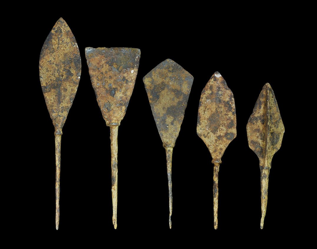 Medieval Iron Arrowhead Collection: 12th-16th century AD. A mixed group of large arrowheads comprising: one tanged, three blades; two tanged, leaf-shaped; one tanged, chisel type; one tanged, rhomboid. 122 grams, 11-14cm (4 1/4 - 5 1/2"