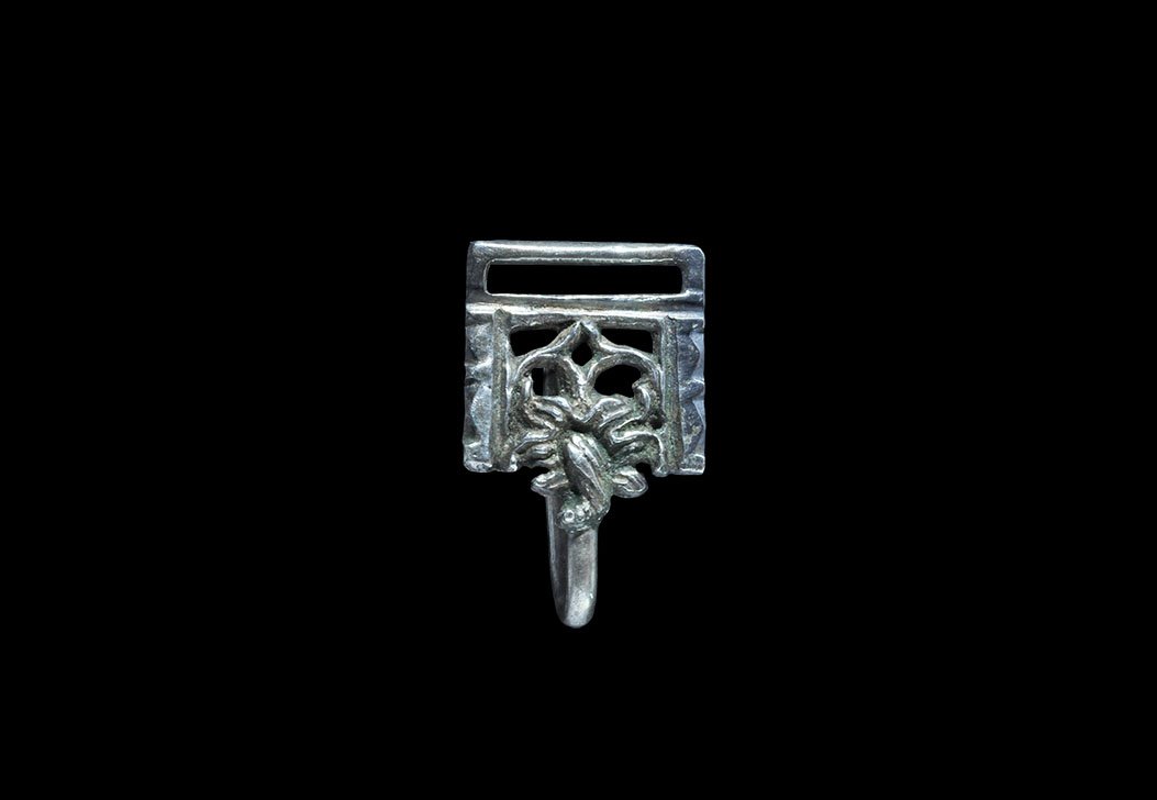 Post Medieval Tudor Silver Decorated Clothes Fastener: 16th century AD. A cast openwork clasp of Class E with rectangular slot above, ogival arch and floral lower edge, sharp recurved hook. 4.62 grams, 29mm (1 1/4"). Ex Robinson collection, Lincolnshire, 