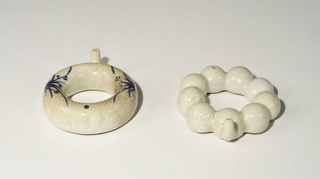 Chinese Ceramic Baby Feeder Group: Ming Dynasty, 1368-1644 AD. A group of two annular baby-feeeders, comprising: one formed as a blue-glazed ring of nine connected bulbs, small curved pipe to one side, vent opposite; one tubular with p