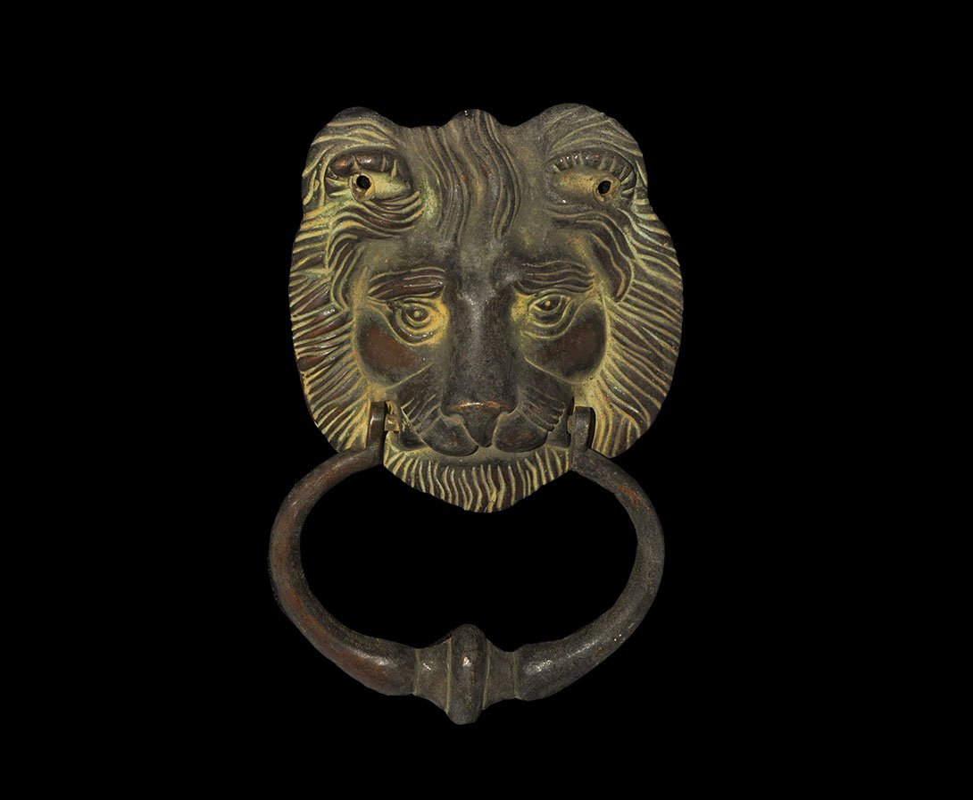 Indian Bronze Lion Head Door Handle: India, 19th-early 20th century AD. Cast bronze lion handle with ring in mouth; holes in ears for nails to attach to door. 567 grams, 16.5cm (6 1/2"). Private collection, London, UK; acquired prior to 